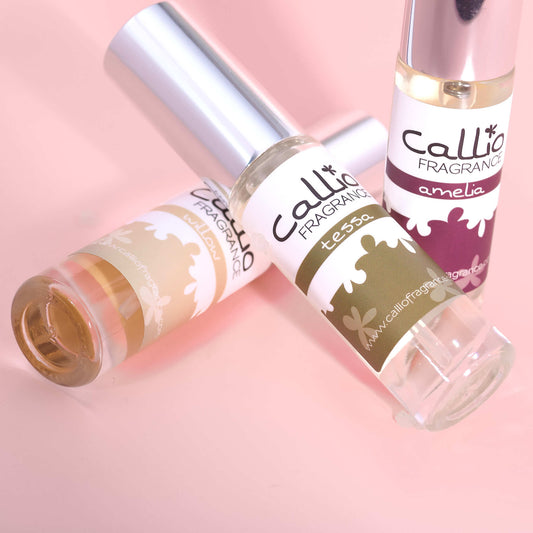Travel size bottles of Willow, Tessa and Amelia on a pink background.