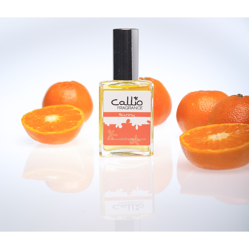 Image of a one-ounce bottle of Sunny Perfume by Callio Fragrance, featuring notes of mandarin orange, orange blossom, jasmine, and vanilla surrounded by freshly slice mandarin oranges.